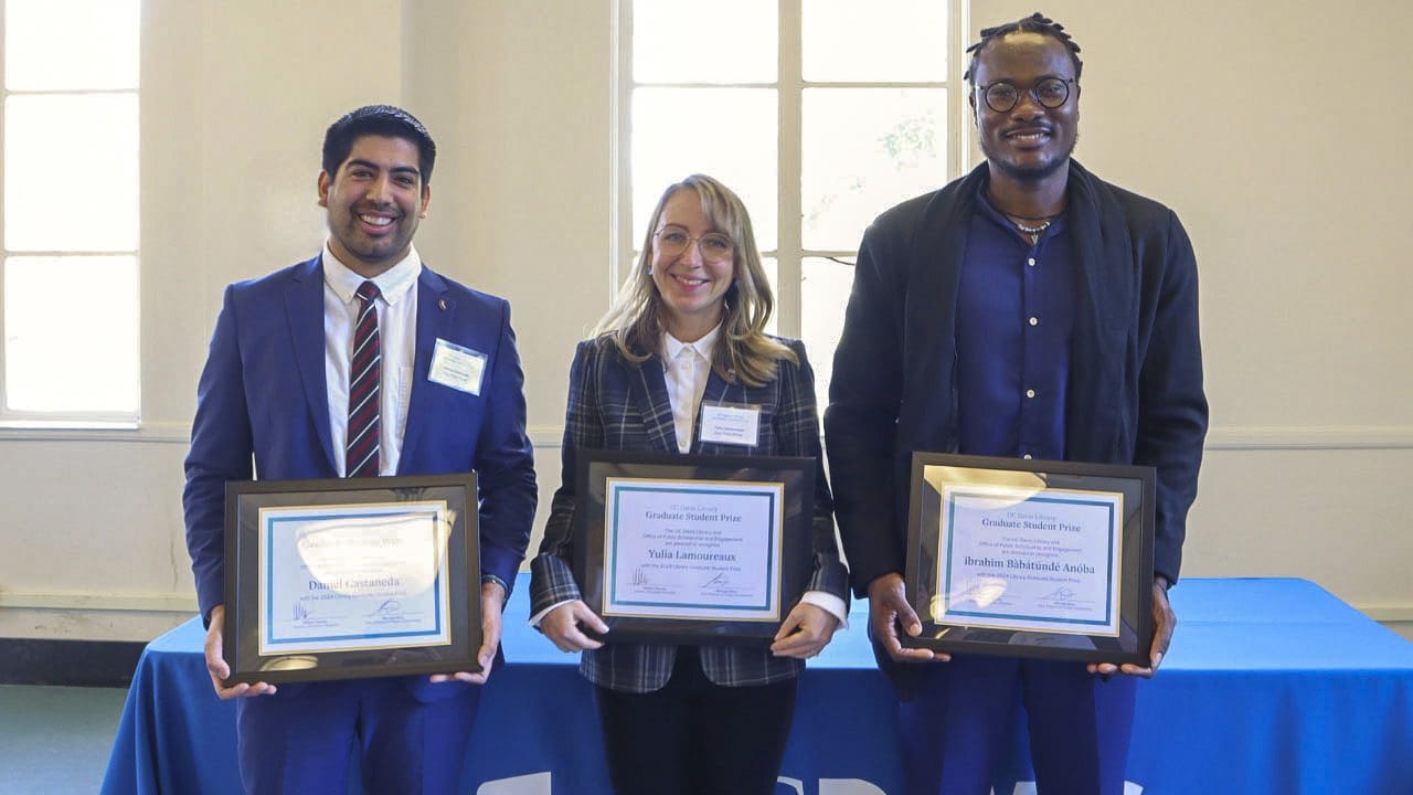 2024 Library Graduate Student Prize winners Daniel Castaneda, Yulia Lamoureaux, and ibrahim Bàbátúndé Anọ́ba pose holding their award certificates.